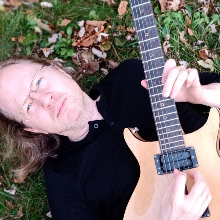 John Griffith holding his guitar
